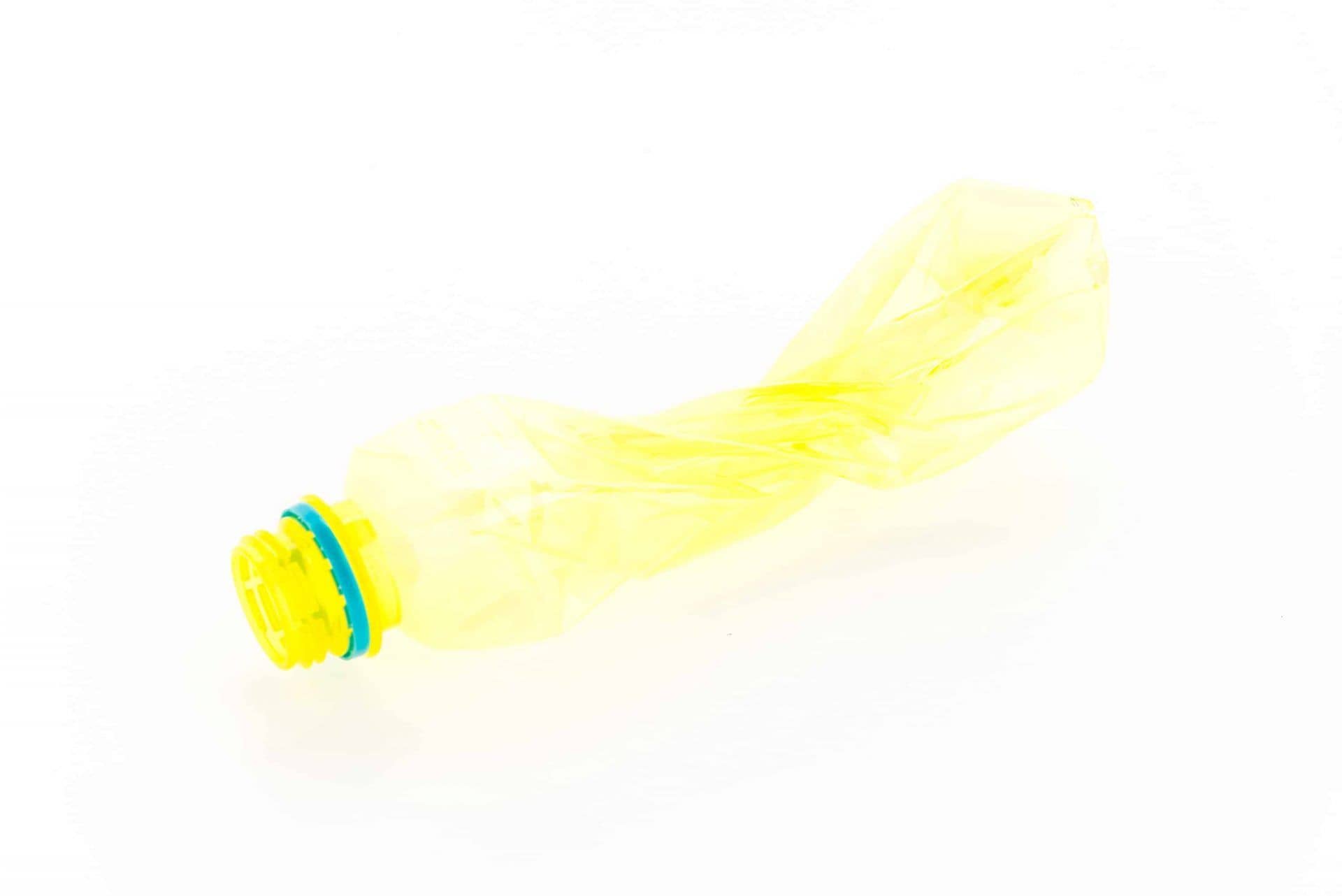Yellow plastic bottle isolated on white background