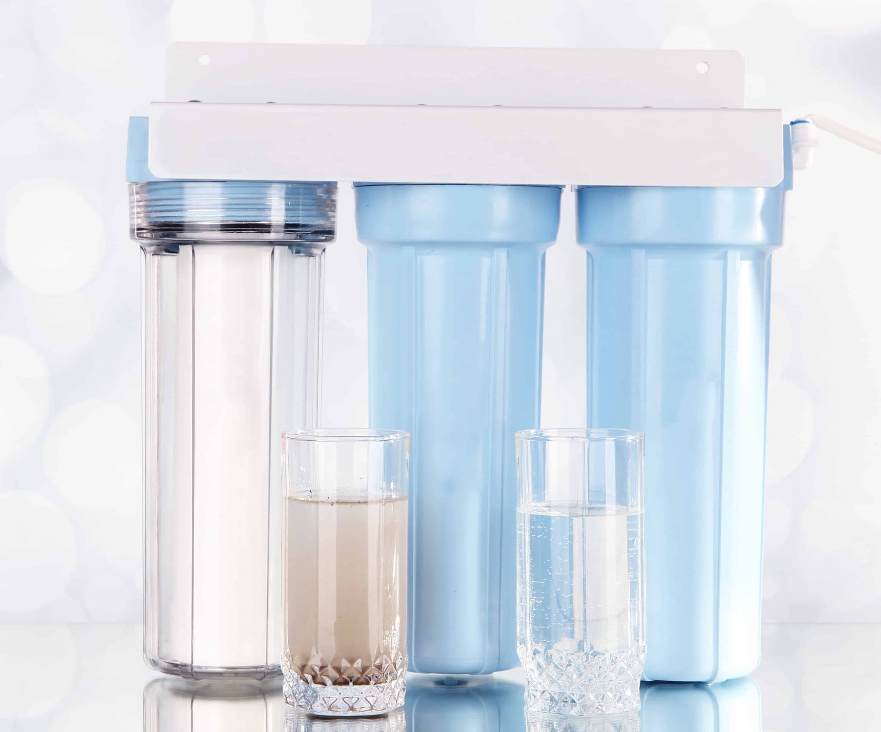Filter system for water treatment with glasses of clean and dirty water on bright background