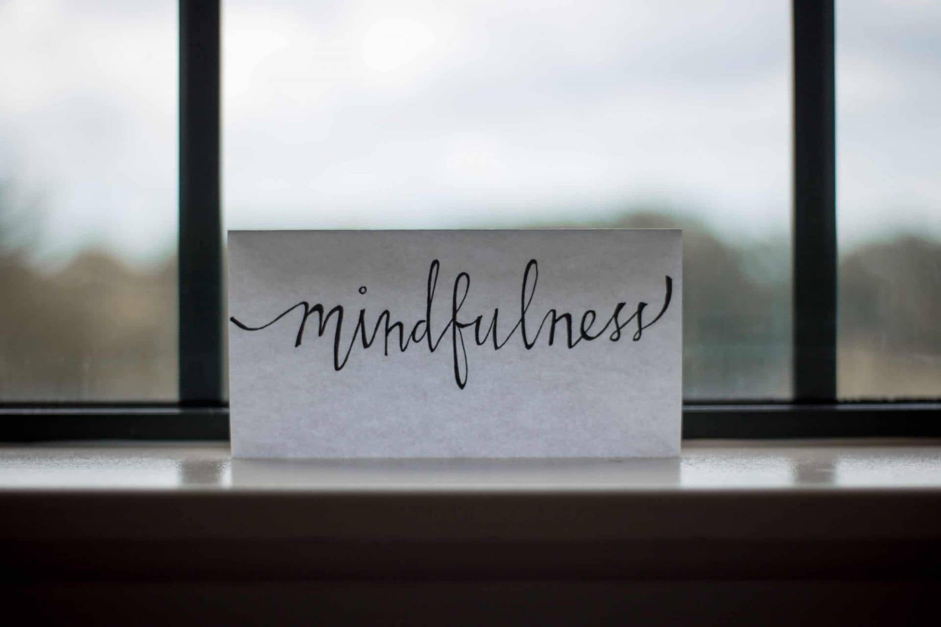 image of piece of paper on a desk with words "Mindfulness" 